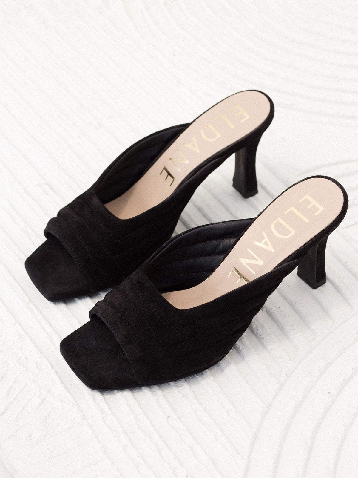 Leather quilted mules in black suede
