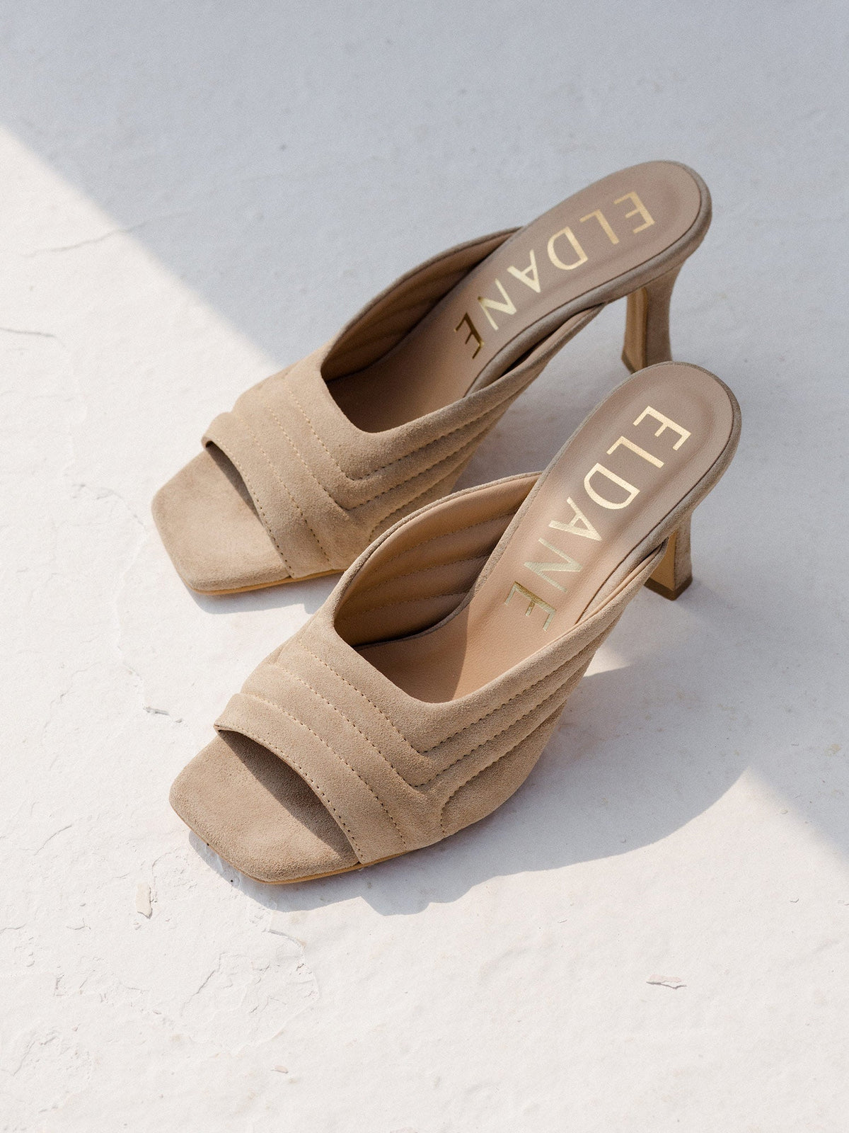 Leather quilted mules in sand suede
