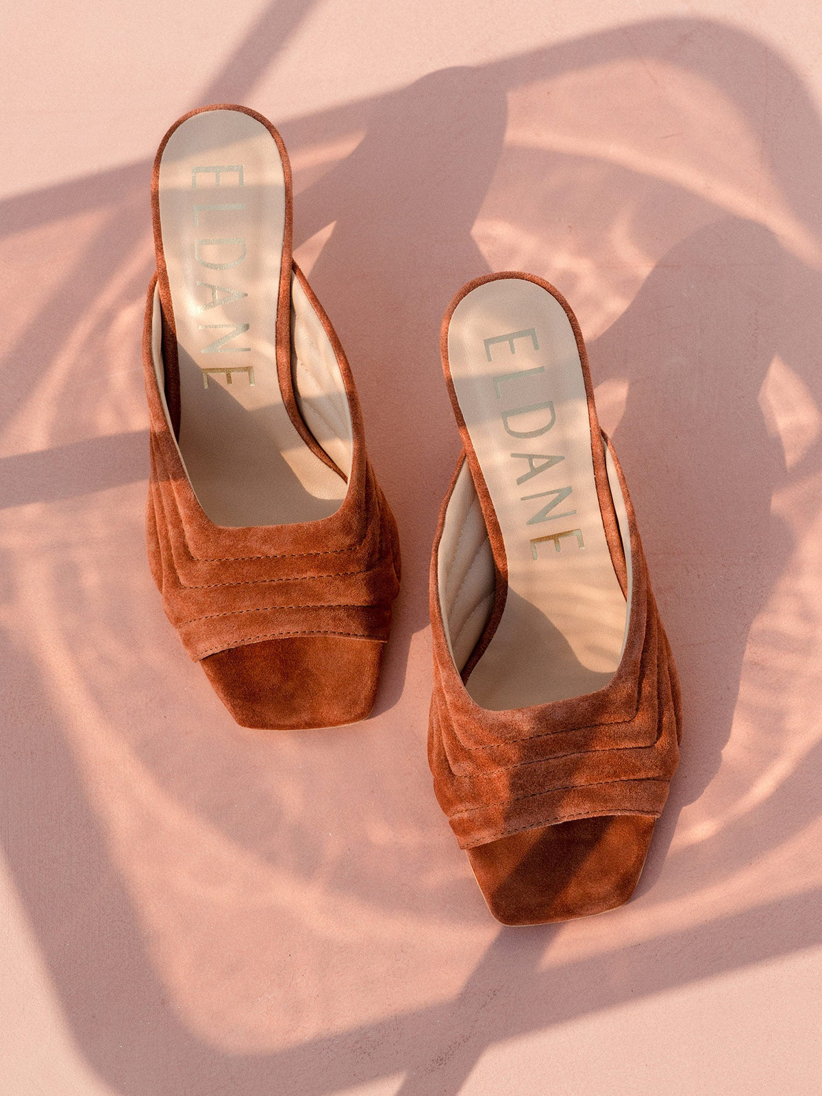 Leather quilted mules in terracotta suede