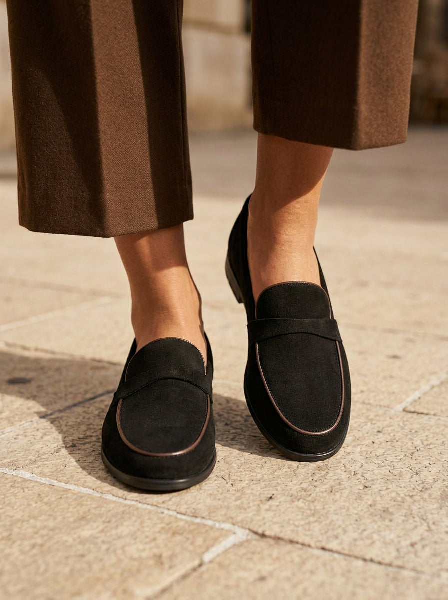 WORKSHOP Leonie Black — suede-texture penny loafers, contrasting tan piping, styled product view